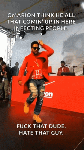 a man in a red coat is dancing in front of a verizon sign
