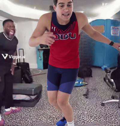 A Man In A Red Dibu Tank Top Is Jumping In The Air GIF