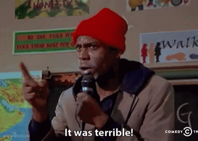 A Man In A Red Hat Is Holding A Microphone And Says It Was Terrible GIF