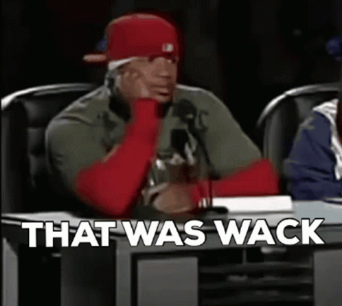 A Man In A Red Hat Is Sitting At A Table With The Words `` That Was Wack '' Written On The Screen . GIF