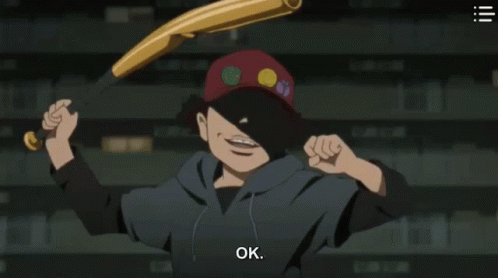 A Man In A Red Hat Is Standing In Front Of A Shelf With Books . GIF