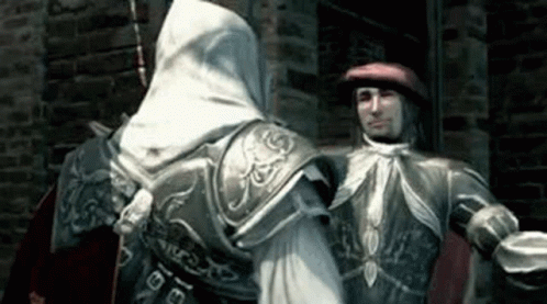 Man In Red Hat Next To Man In White Hood GIF