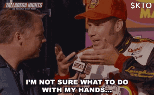 A Man In A Red Hat Is Talking To Another Man While Holding A Espn Microphone GIF
