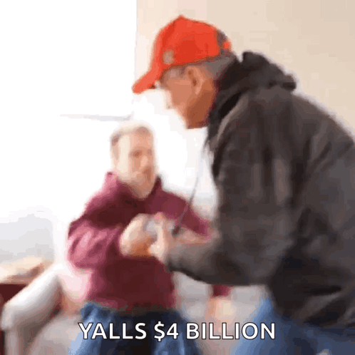 A Man In A Red Hat Says Yalls $ 4 Billion In Front Of Another Man GIF