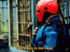 A Man In A Red Helmet Is Holding A Gun And Saying Put A Gun To His Head GIF