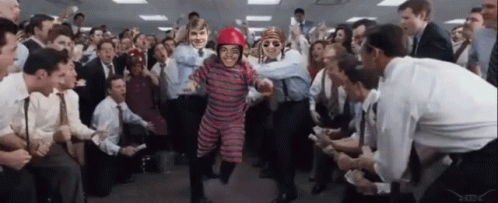 A Man In A Red Helmet Is Surrounded By People GIF