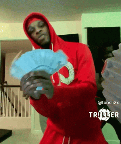 A Man In A Red Hoodie Holds A Fan Of Money GIF