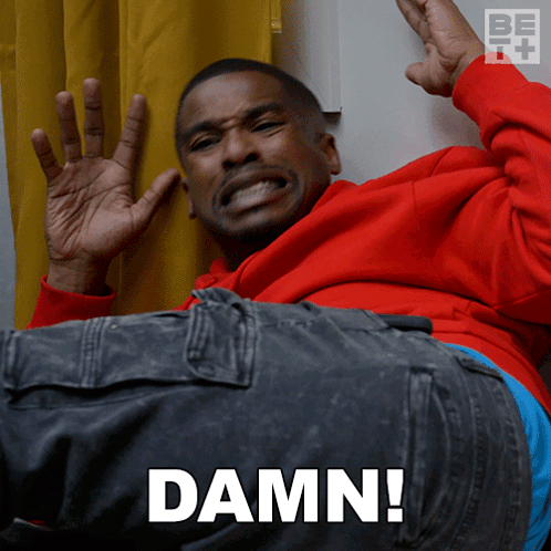 A Man In A Red Hoodie Is Laying Down With The Word Damn Written On The Bottom GIF