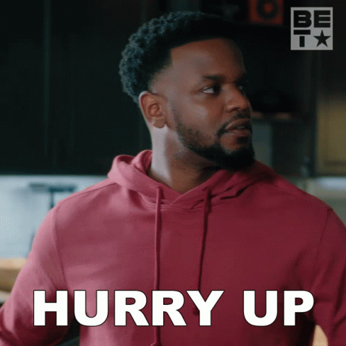 A Man In A Red Hoodie Says Hurry Up In White GIF