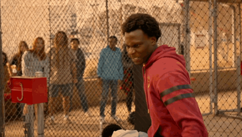 A Man In A Red Hoodie With The Letter J On It GIF