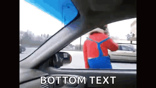 A Man In A Red Jacket And Blue Overalls Is Standing In A Car With The Words Bottom Text Written Below Him GIF