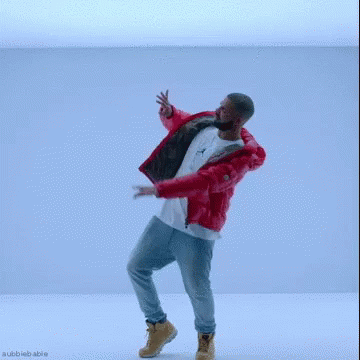 A Man In A Red Jacket And Jeans Is Dancing In A Blue Room . GIF