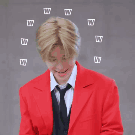 A Man In A Red Jacket And Tie Is Laughing With Letters W Flying Around Him GIF