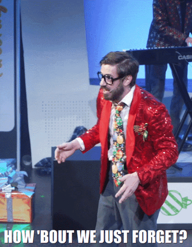 A Man In A Red Jacket And Tie Stands In Front Of A Keyboard That Says Casio On It GIF