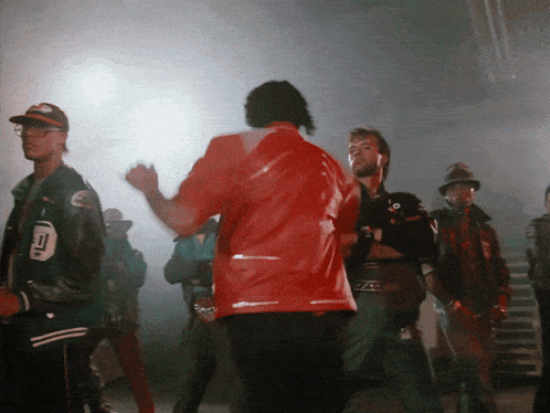 A Man In A Red Jacket Has The Number 10 On His Back GIF