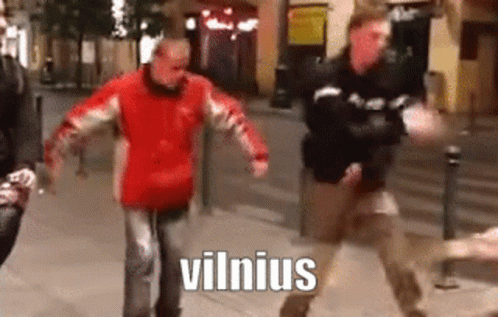 A Man In A Red Jacket Is Dancing On A Sidewalk With The Word Vilnius Written On The Bottom . GIF