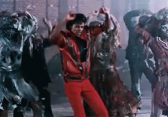 A Man In A Red Jacket Is Dancing With A Group Of Zombies In A Dark Room . GIF