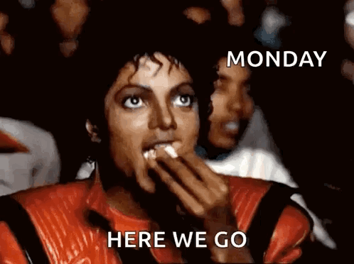 A Man In A Red Jacket Is Eating Popcorn With The Words Monday Here We Go Below Him GIF