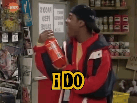 A Man In A Red Jacket Is Holding A Can Of Soda With The Word Ido On It GIF