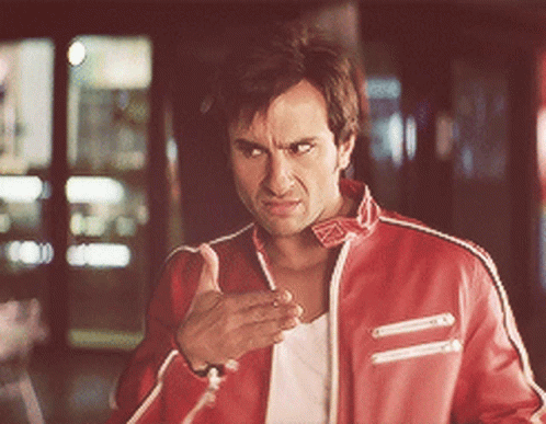 A Man In A Red Jacket Is Making A Funny Face GIF