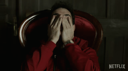 A Man In A Red Jacket Is Sitting In A Chair With Netflix Written In The Corner GIF