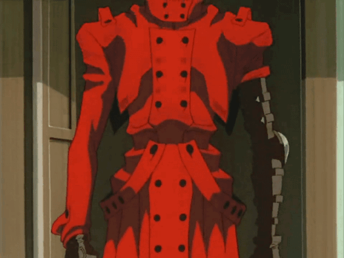 A Man In A Red Jacket Is Standing In A Doorway And Smiling GIF