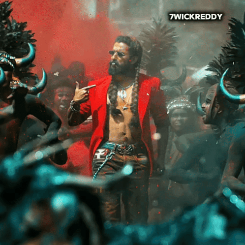A Man In A Red Jacket Is Standing In Front Of A Crowd And The Words 7Wickreddy Are On The Bottom Right GIF