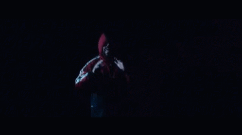 A Man In A Red Jacket Is Standing In Front Of A Group Of Dancers Holding Drums GIF
