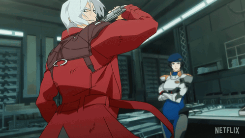 A Man In A Red Jacket Is Standing Next To A Woman In A Blue Uniform With A Netflix Logo On The Bottom Right GIF
