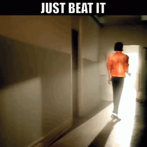 A Man In A Red Jacket Is Walking Down A Hallway With The Words Just Beat It Below Him GIF