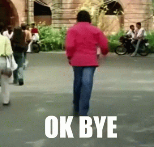 A Man In A Red Jacket Is Walking Down A Street With The Words Ok Bye Written On The Ground . GIF