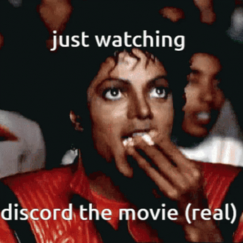 A Man In A Red Jacket Is Watching A Movie And Says Just Watching Discord The Movie ( Real ) GIF