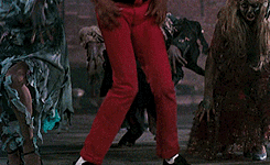 A Man In A Red Jacket Says Aaow In Front Of A Group Of Zombies GIF
