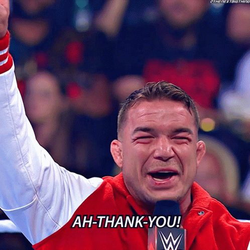 A Man In A Red Jacket Says Ah-Thank-You In Front Of A Microphone GIF