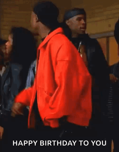 A Man In A Red Jacket Says " Happy Birthday To You " While Smoking A Cigarette GIF