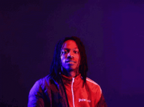 A Man In A Red Jacket Stands In Front Of A Sign That Says The More You Know GIF
