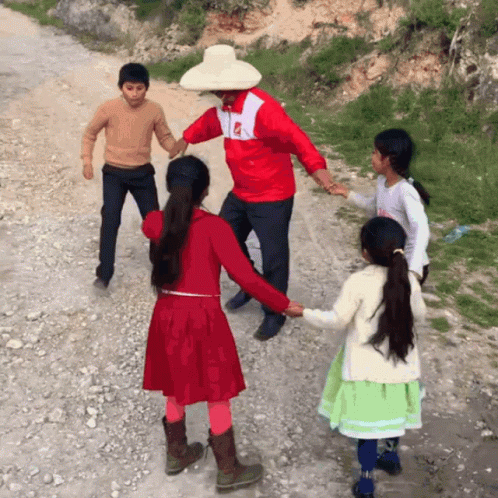 A Man In A Red Jacket With The Letter P On It Is Holding Hands With A Girl In A Red Dress GIF