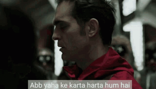 A Man In A Red Jacket With The Words Abb Yaha Ke Karta Harta Hum Hai Above Him GIF