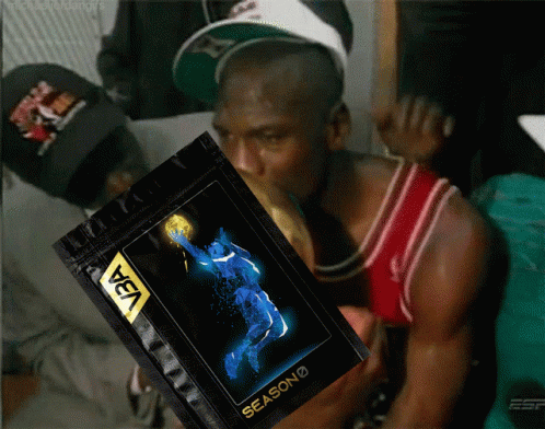 A Man In A Red Jersey Is Holding A Bag That Says Season On It GIF