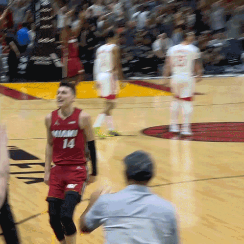 A Man In A Red Jersey With The Number 14 On The Front GIF
