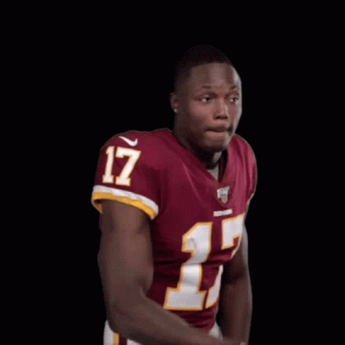 A Man In A Red Jersey With The Number 17 On It Is Making A Funny Face . GIF