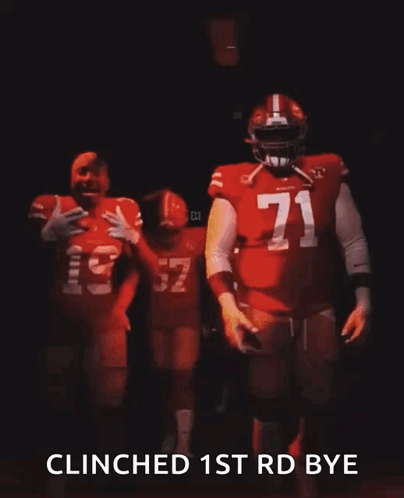 A Man In A Red Jersey With The Number 32 On It Is Walking In The Dark . GIF