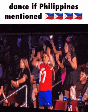 A Man In A Red Jersey With The Number 37 On It Stands In Front Of A Crowd GIF