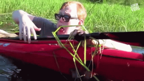 A Man In A Red Kayak With The Words Jukin Vibe On The Bottom Right GIF