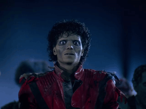A Man In A Red Leather Jacket Is Looking At The Camera GIF