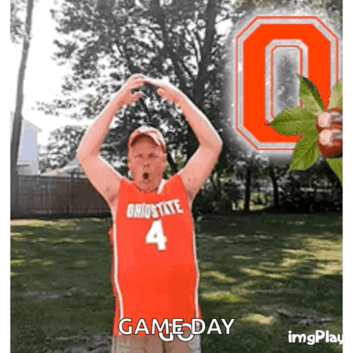 A Man In A Red Ohio State Jersey Stands In Front Of A Large Ohio State Logo GIF