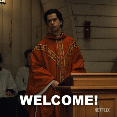 A Man In A Red Robe Is Standing In Front Of A Podium That Says Welcome Netflix GIF