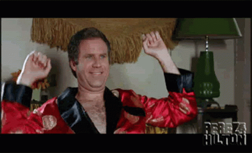 A Man In A Red Robe With The Name Perez Hilton On The Bottom Left GIF