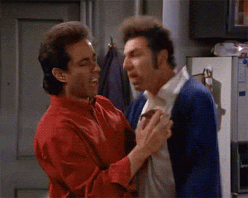 a man in a red shirt and a man in a blue cardigan are fighting