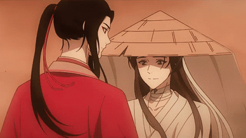 A Man In A Red Shirt And A Woman In A White Shirt Are Looking At Each Other GIF